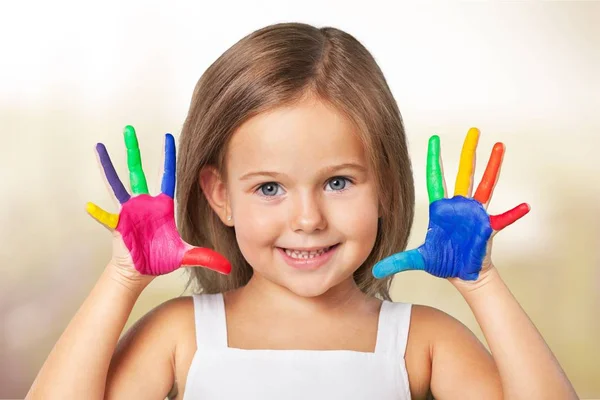 Little girl showing painted hands — Stock Photo, Image