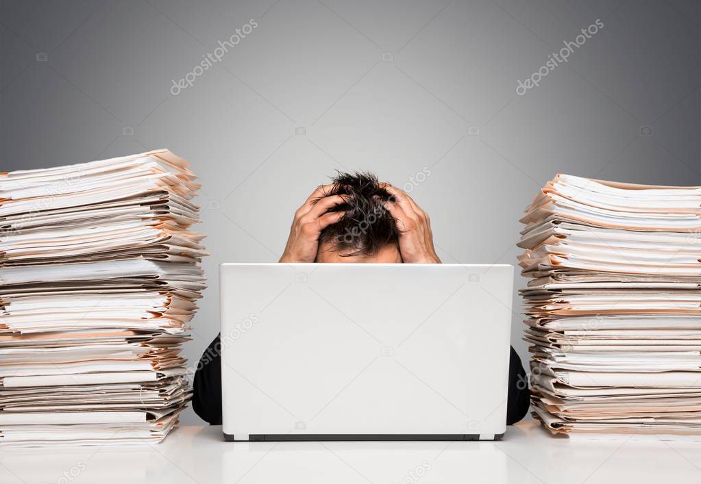 young businessman with stack of papers