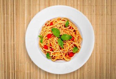 Beyaz tabak içinde domatesli makarna