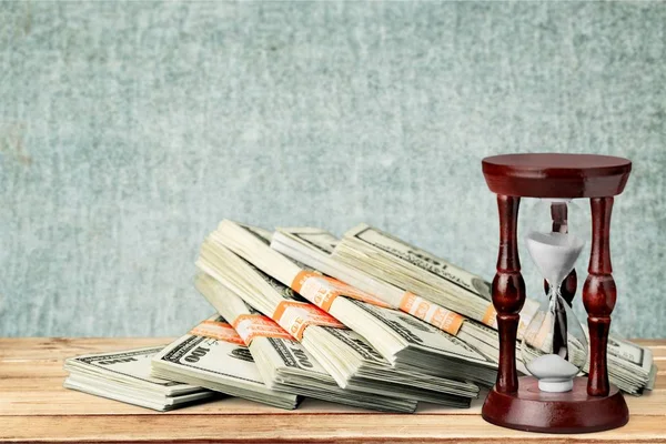 Hourglass with currency — Stock Photo, Image