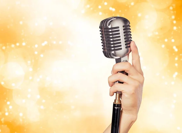 Hand holding microphone — Stock Photo, Image