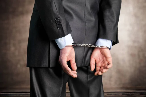 Man in handcuffs behind his back — Stock Photo, Image