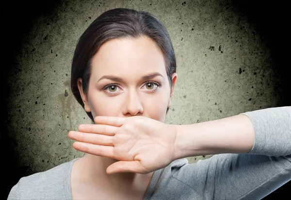 Woman shutting mouth with hand — Stock Photo, Image