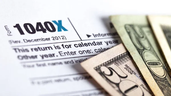 US Federal tax 1040 income tax form with money