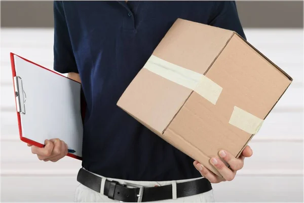 Young man standing with box — Stock Photo, Image