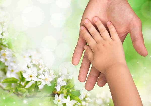 Hands of a child and a father 