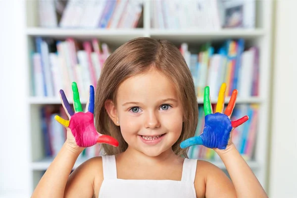 Little girl showing painted hands — Stock Photo, Image