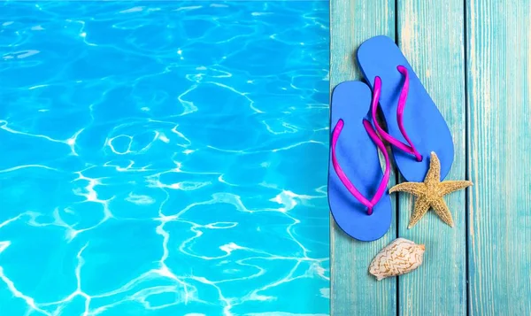 Mušle a flip-flop na vodě — Stock fotografie