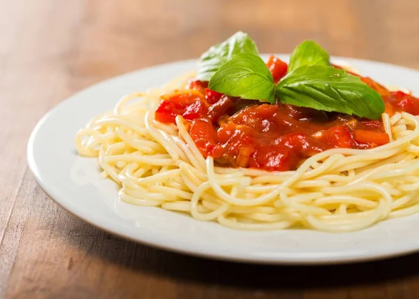 Pasta con tomates en plato blanco — Foto de Stock
