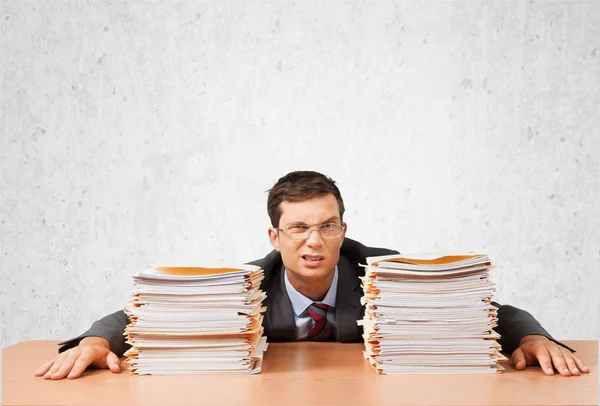 Business man with heap of papers — Stock Photo, Image