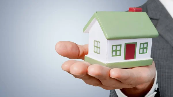 Hand of man holding house model — Stock Photo, Image