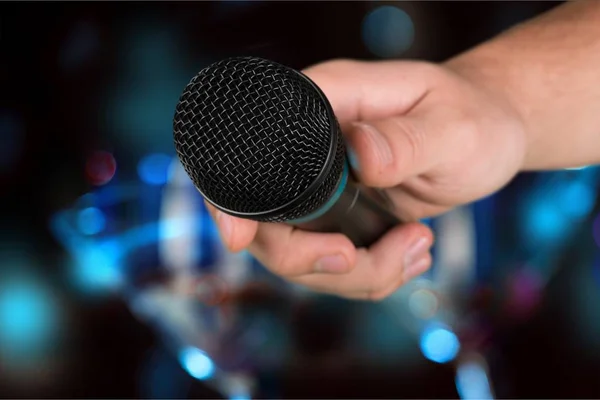 Hand holding microphone — Stock Photo, Image