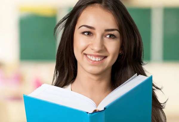 Woman with book smiling — Stock Photo, Image