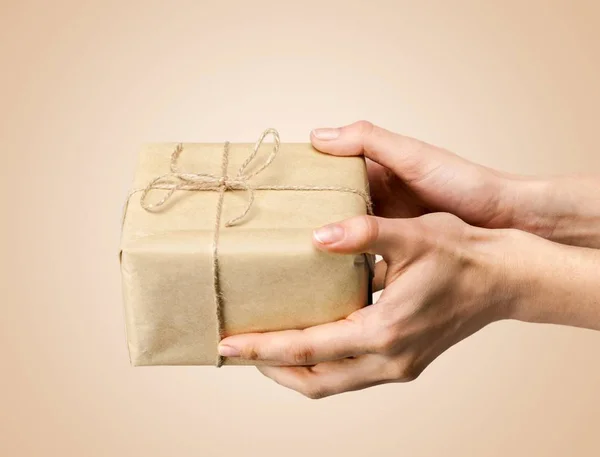 Human hands holding gift — Stock Photo, Image