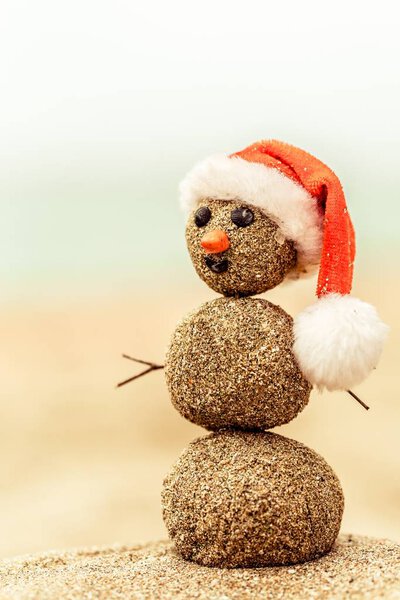 Sandy snowman on beach