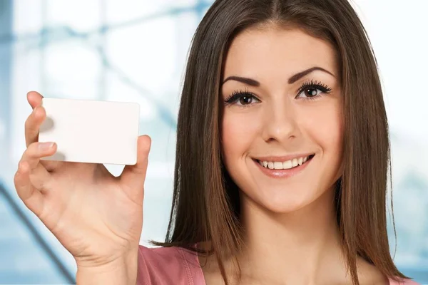 Cute woman holding white card Stock Photo