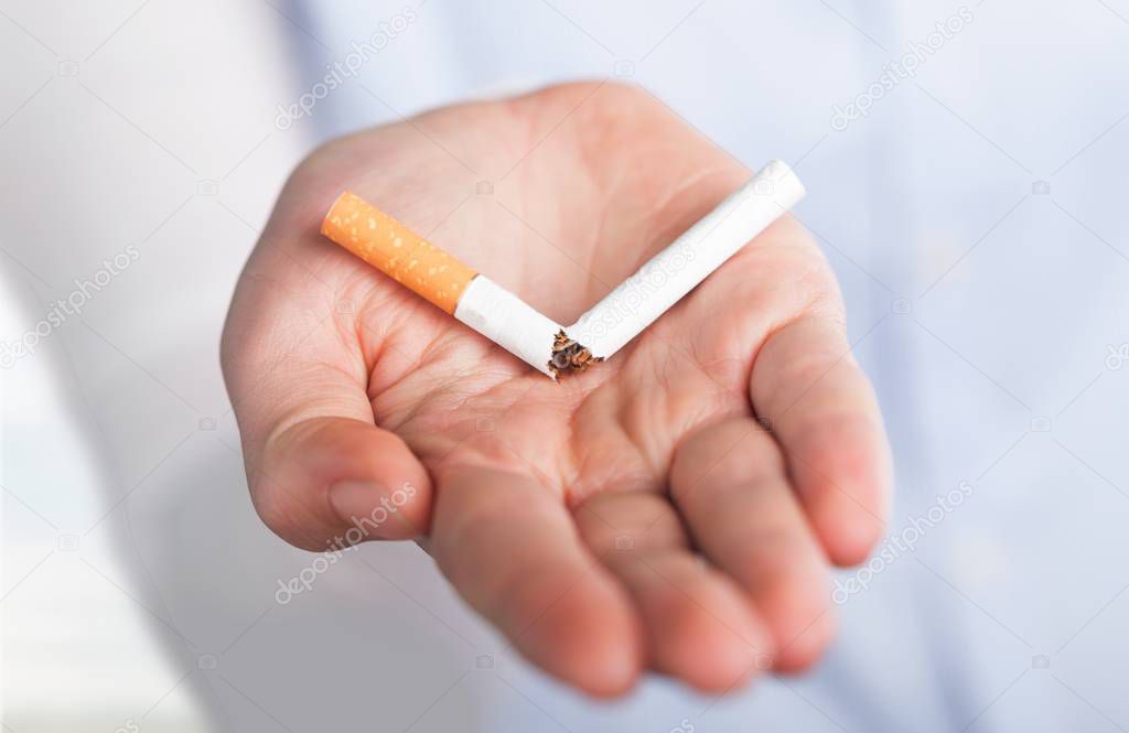 hand holding broken cigarette