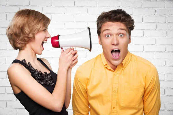 Irritado jovem casal com megafone — Fotografia de Stock