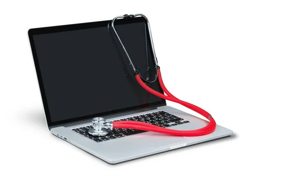 Stetoskop wiszący na laptopie — Zdjęcie stockowe