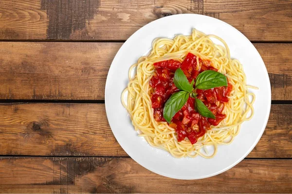 Pasta with tomatoes in white plate — Stock Photo, Image