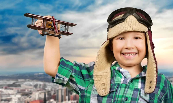 Little boy with wooden plane — Stock Photo, Image