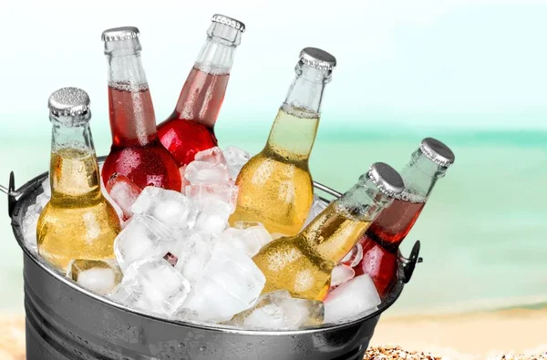 Beer bottles in ice — Stock Photo, Image