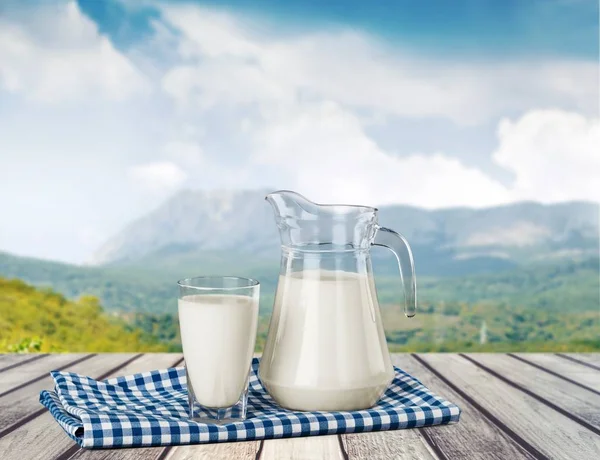 Glass of milk and jug — Stock Photo, Image