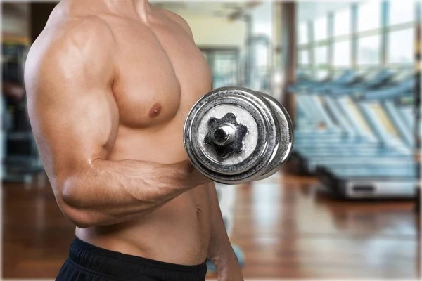 Muscled man with dumbbell — Stock Photo, Image