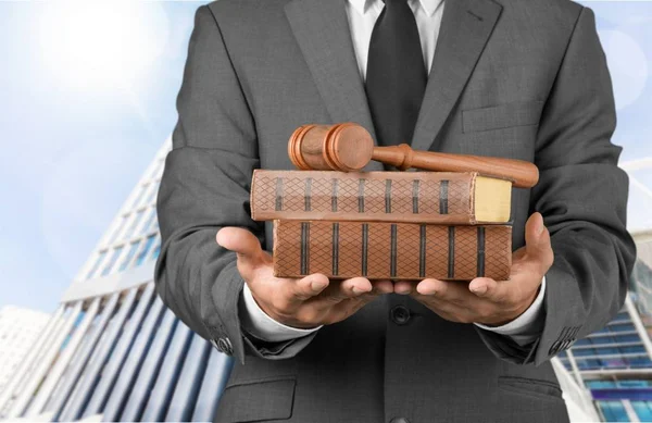 Male hands with wooden judge hammer — Stock Photo, Image