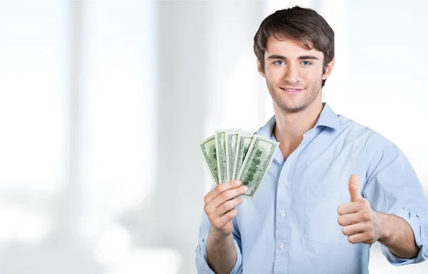 Muž s dolary ukazuje palec — Stock fotografie