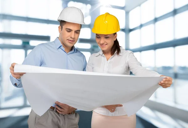 Young couple working in helmet — Stock Photo, Image