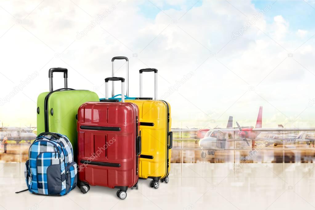 colorful suitcases and backpack 