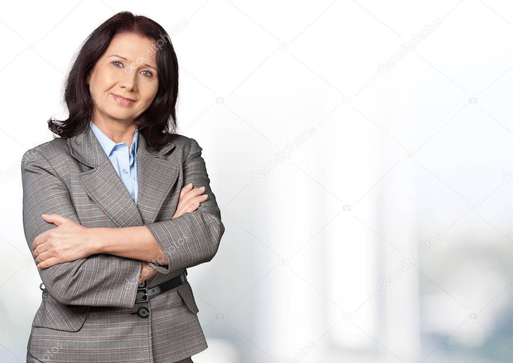 brunette woman in grey suit