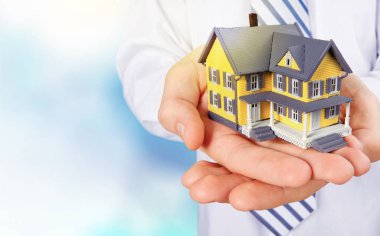 hands holding house model clipart