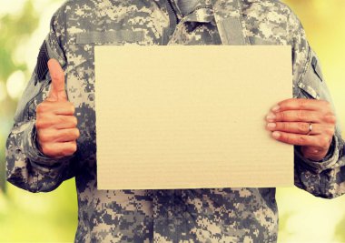 military man holding empty board clipart