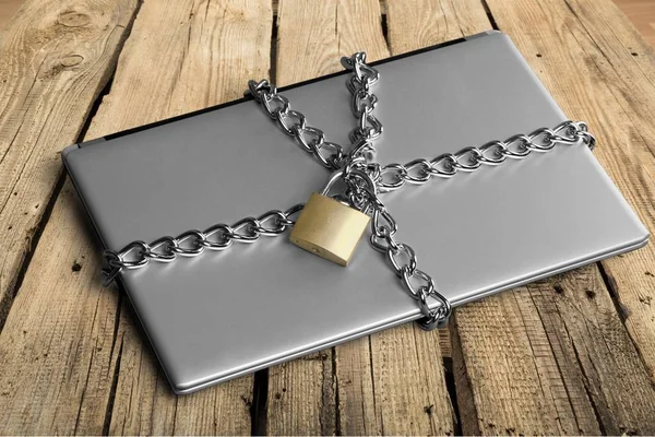 Laptop with chains and padlock — Stock Photo, Image