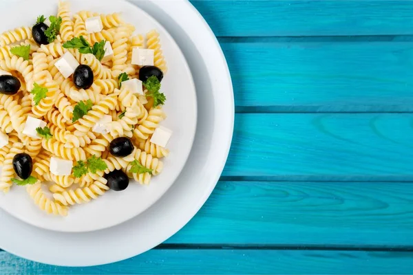 Pasta with tomatoes in white plate — Stock Photo, Image