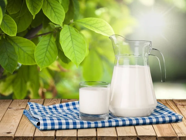 Glass of milk and jug — Stock Photo, Image