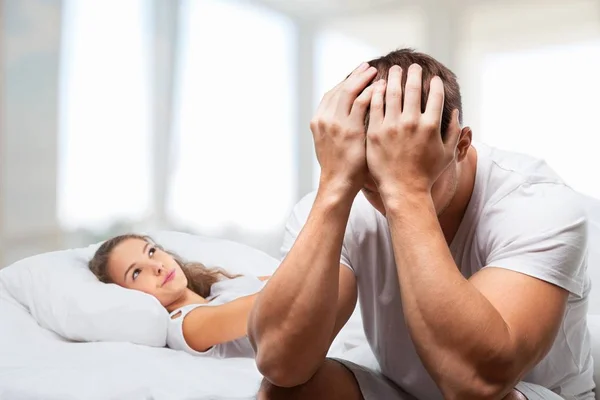 Sad couple in bed — Stock Photo, Image