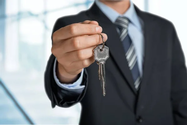 Business man holding key — Stock Photo, Image