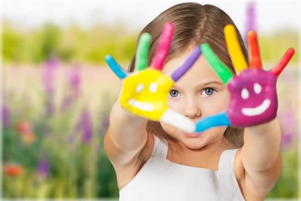 Little girl showing painted hands — Stock Photo, Image