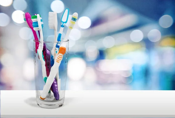 New Colorful Toothbrushes in Glass — Stock Photo, Image