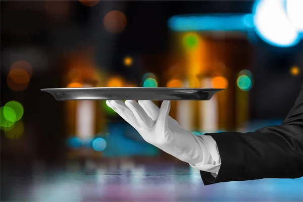 Waiter holding silver tray — Stock Photo, Image