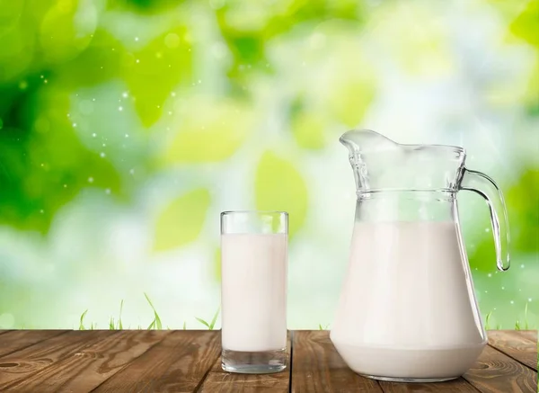 Glass of milk and jug — Stock Photo, Image