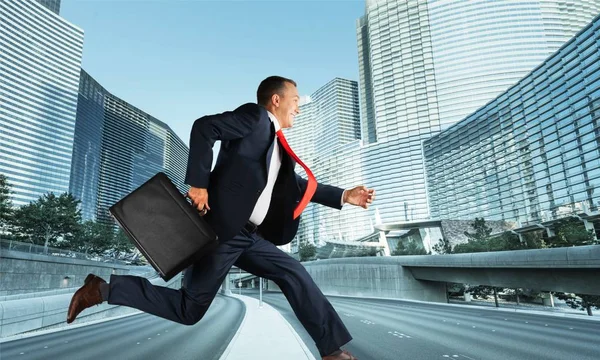 running businessman with briefcase