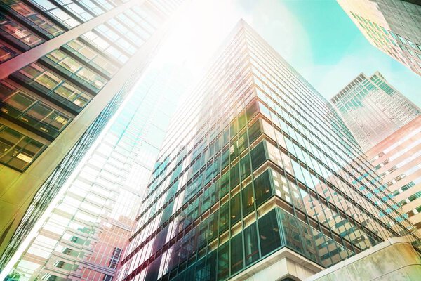 Modern office glass buildings over sky background