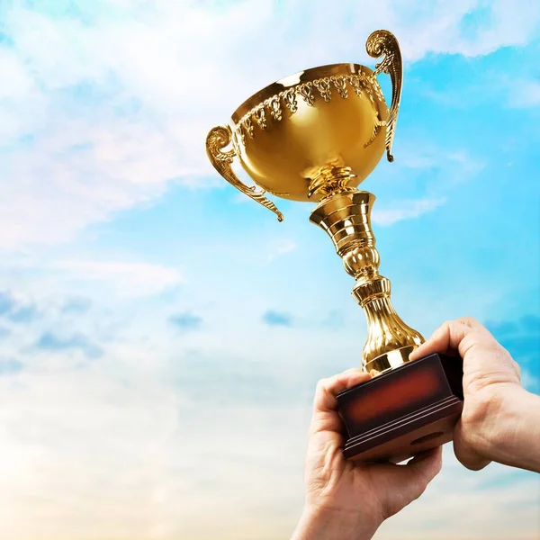 Hands holding golden Trophy — Stock Photo, Image