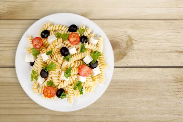 Pasta with tomatoes in white plate — Stock Photo, Image