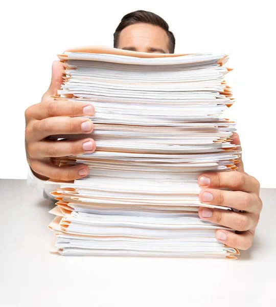 Businessman near heap of papers — Stock Photo, Image