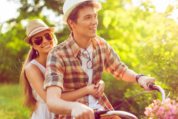 Happy couple riding bicycle outdoors — Stock Photo, Image